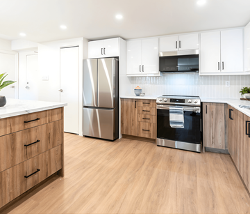 Kitchener apartment for rent - A kitchen with wooden cabinets and a stainless steel refrigerator.