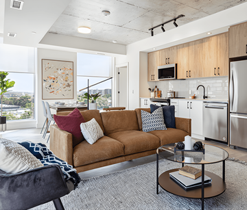 Ottawa apartment for rent - A modern living room with a brown sofa and a glass coffee table.