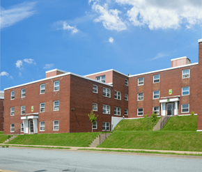 Dartmouth apartment for rent - A red brick building with a green sign on the front.