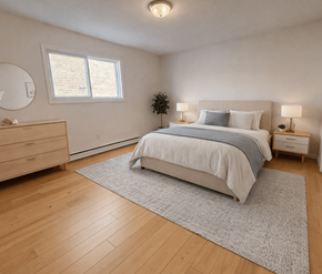 Moncton apartment for rent - A bedroom with a large bed, a dresser, and a window.