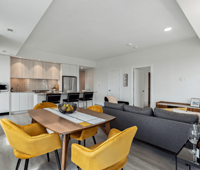 Ottawa apartment for rent - A modern kitchen with a dining table and yellow chairs.
