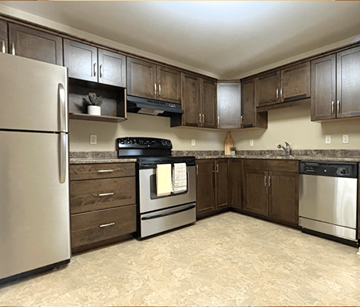 Dieppe apartment for rent - A kitchen with a refrigerator, oven, and sink.