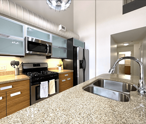 Dieppe apartment for rent - A kitchen with a granite countertop and stainless steel appliances.