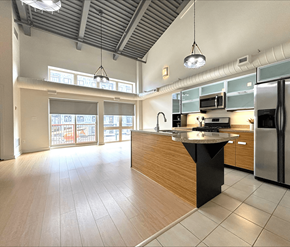 Dieppe apartment for rent - A kitchen with a black island in the middle of it.
