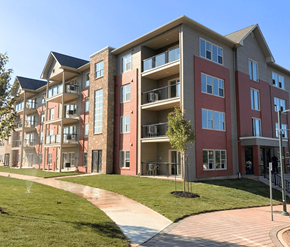 Dieppe apartment for rent - A multi-story apartment building with a walkway in front.