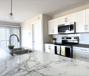 Moncton apartment for rent - A kitchen with a marble countertop and stainless steel appliances.