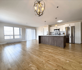 Moncton apartment for rent - A kitchen with a wooden floor and a large island.