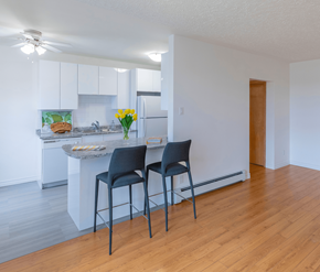 Moncton apartment for rent - Two chairs are placed in front of a kitchen island.