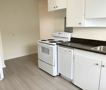 Dartmouth apartment for rent - A white stove and dishwasher in a kitchen with white cabinets.