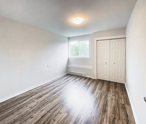 St. Johns apartment for rent - A room with wooden flooring and a white door.