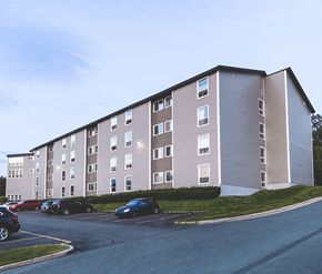 St. Johns apartment for rent - A large apartment building with a parking lot in front.