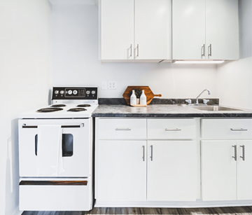 St. John's apartment for rent - A white kitchen with a stove and cabinets.