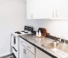 St. Johns apartment for rent - A kitchen with a stove, sink, and cabinets.