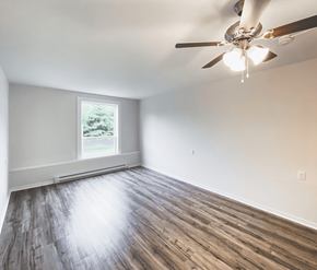 St. Johns apartment for rent - A room with a ceiling fan and wooden flooring.
