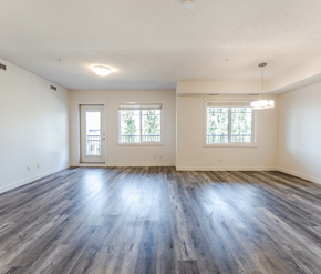 Edmonton apartment for rent - A spacious room with wooden floors and two windows.