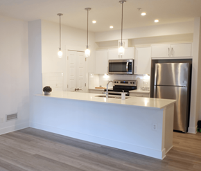 Calgary apartment for rent - A modern kitchen with a white countertop and stainless steel appliances.