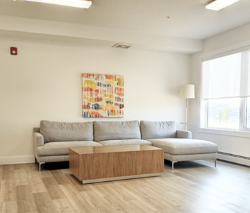 Calgary apartment for rent - A living room with a grey couch and a wooden coffee table.