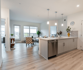 Calgary apartment for rent - A modern kitchen with a dining table and chairs.