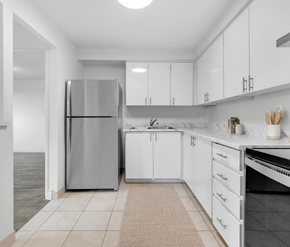 Waterloo apartment for rent - A modern kitchen with white cabinets and a stainless steel refrigerator.