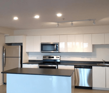 Halifax apartment for rent - A modern kitchen with a stainless steel dishwasher and a black countertop.