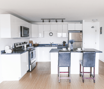 St. John's apartment for rent - A kitchen with a black countertop and white cabinets.