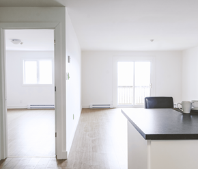 St. Johns apartment for rent - A black countertop with a white fridge and a black chair in the middle of the room.