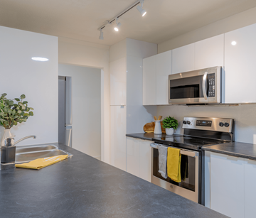 Fredericton apartment for rent - A modern kitchen with a stainless steel oven and microwave.