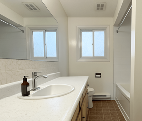 Waterloo apartment for rent - A bathroom with a white sink and brown tiles.