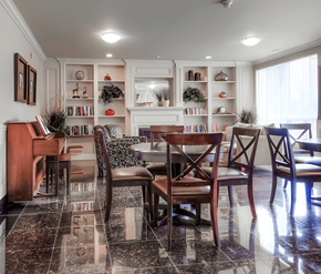 London apartment for rent - A dining room with a piano and a table set for four.