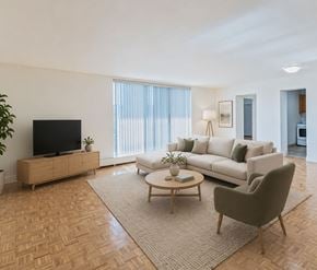 Kitchener apartment for rent - A living room with a sofa, a coffee table, and a television.