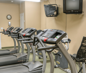 Cambridge apartment for rent - A gym with treadmills and a television mounted on the wall.