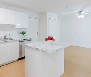Saint John apartment for rent - A kitchen with white cabinets and a marble island.