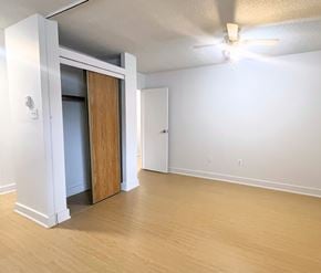 St. Johns apartment for rent - A room with a ceiling fan and a doorway leading to another room.