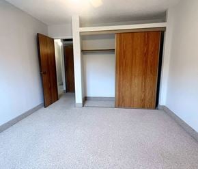St. Johns apartment for rent - A room with a carpeted floor and two wooden doors.