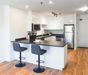St. Johns apartment for rent - A kitchen with a black countertop and two bar stools.