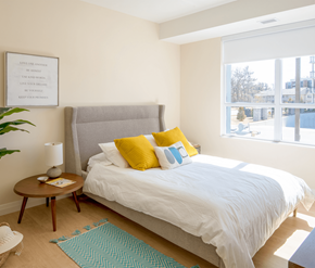 Cambridge apartment for rent - A bedroom with a large bed and a framed quote on the wall.