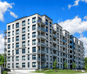 Cambridge apartment for rent - A large white apartment building with balconies and multiple windows.