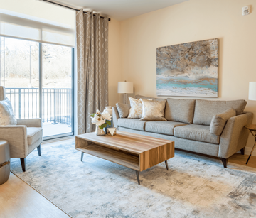 Cambridge apartment for rent - A living room with a grey couch, a wooden coffee table, and a painting on the wall.
