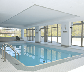Mississauga apartment for rent - A large indoor swimming pool with a sign that says "JEEP AREA" on the wall.