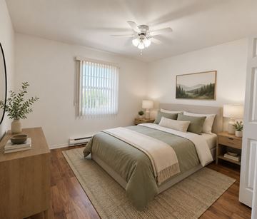 Riverview apartment for rent - A bedroom with a large bed and a ceiling fan.