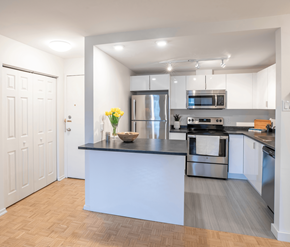 Saint John apartment for rent - A kitchen with a black countertop and stainless steel appliances.