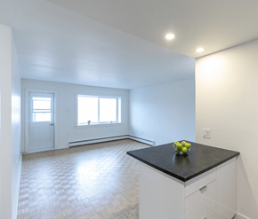 Saint John apartment for rent - A kitchen with a black countertop and white cabinets.