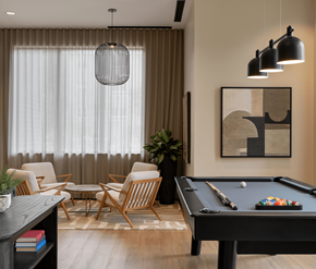 Waterloo apartment for rent - A pool table is in the middle of a room with a chair and a plant.