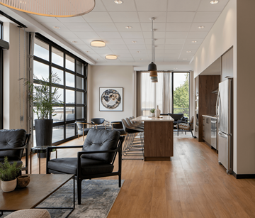 Waterloo apartment for rent - A modern living room with black leather chairs and a wooden coffee table.