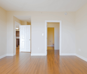 Dartmouth apartment for rent - A room with a white door and a wooden floor.