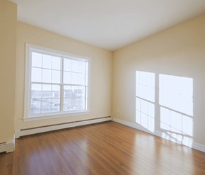 Dartmouth apartment for rent - A room with a large window and wooden flooring.