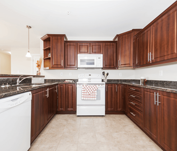 Dartmouth apartment for rent - A kitchen with brown cabinets and white appliances.