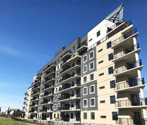 Edmonton apartment for rent - A large, modern building with a unique triangular top.