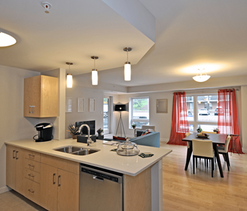 Fredericton apartment for rent - A kitchen with wooden cabinets and a white countertop.