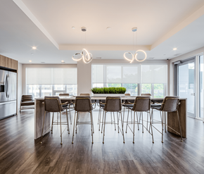 Mississauga apartment for rent - A modern dining room with a long table and chairs.
